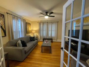 a living room with a couch and a ceiling fan at A new Renovated cozy three Bedrooms APT in Pawtucket