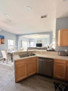 a kitchen with a sink and a counter top at Luxry villa 6 miles from Disney in Orlando