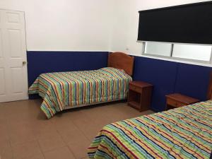 a hotel room with two beds and a tv at POSADA COPACABANA in Tocopilla