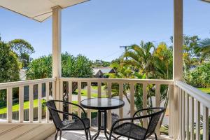 un tavolo e sedie su una veranda con vista sull'oceano di 11 Dalmor Court a Coolum Beach