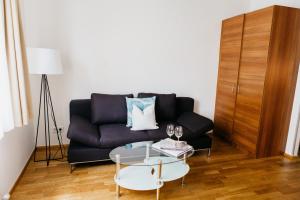 a living room with a couch, coffee table and a lamp at Home Sweet Apartments | contactless check-in in Vienna