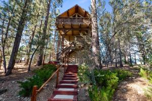 a tree house in the woods at Treehouse On Rainbow - A newly remodeled cabin perfect for a mountain getaway in Big Bear City