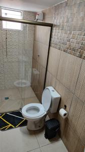 a bathroom with a toilet and a shower at Royal Hotel in Dourados