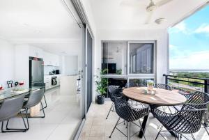 uma cozinha e sala de jantar com mesa e cadeiras em 'Top of Town' Resort-style Stay in Heart of Darwin em Darwin