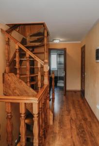a room with a wooden spiral staircase in a house at Фенікс in Yaremche