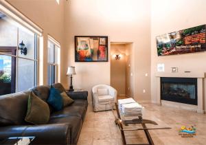 a living room with a leather couch and a fireplace at Come, Experience, Collect memories 24-1 in San Felipe