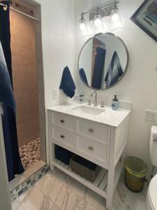a bathroom with a white sink and a mirror at Blue Door Farmhouse in Meeker