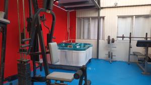 a room with a gym with a sink and a chair at Fitness Suite in Tijuana