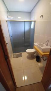 ein Bad mit einer Dusche, einem WC und einem Waschbecken in der Unterkunft Alto do morro in Nova Petrópolis