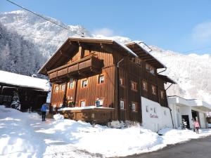 a wooden cabin in the snow with a mountain at Ferienhaus Gerlinde in Sölden