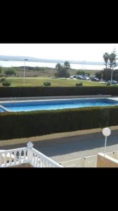 a view of a swimming pool with a white railing at Torrevieja in Torrevieja