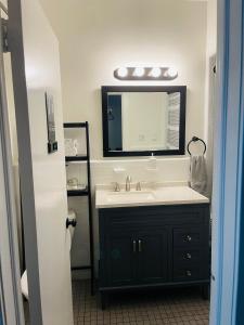 a bathroom with a sink and a mirror at NY3182-9 Private Office w Double SofaBed Keypad in Unionport
