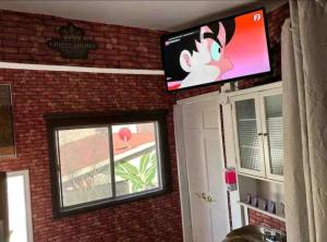 a flat screen tv on the wall of a living room at Tree Cabin in Tijuana