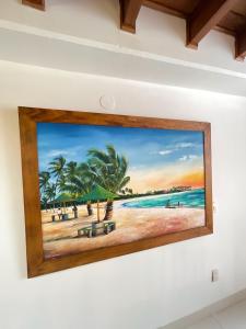 a painting of a beach scene on a wall at Edificio Bahia Fragata Apartamento 411 in San Andrés