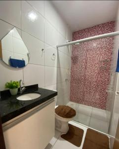 a bathroom with a shower and a toilet and a sink at DUNAS RESIDENCE CASA 02 in Santo Amaro