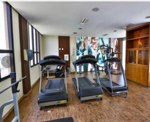 a gym with treadmills and ellipticals in a room at Flat 213 - Comfort Hotel Taguatinga in Taguatinga