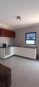 A kitchen or kitchenette at Esteem Guesthouse