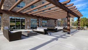 a patio with furniture and a wooden pergola at Holiday Inn Express - Chino Hills, an IHG Hotel in Chino Hills