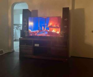 a tv sitting on a dresser in a living room at Cozy Home Away from Home in Clayton