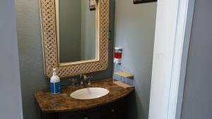 a bathroom with a sink with a mirror and a counter at Presidential Suite in Tijuana