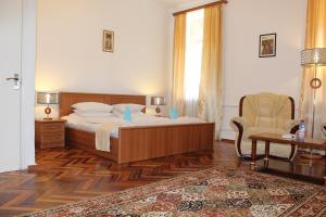 a bedroom with a bed and a chair at Diligence Hotel & restaurant in Dilijan
