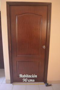 a wooden door with the words installation amps on it at Apartamentos Nokal in Masaya