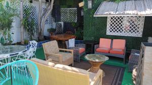 a patio with chairs and tables and a table and chairs at Trendy green Cabin in Tijuana