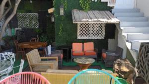 a patio with colorful chairs and tables and stairs at Trendy green Cabin in Tijuana