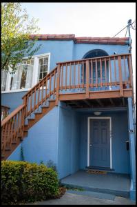 a blue house with a staircase and a door at North Oakland Home w/ 70s Lounge+Patio in Oakland