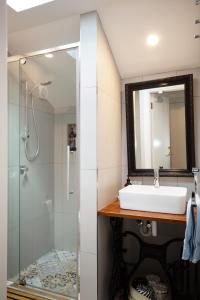 a bathroom with a sink and a shower at Assemblage Boutique Art B & B in Hobart