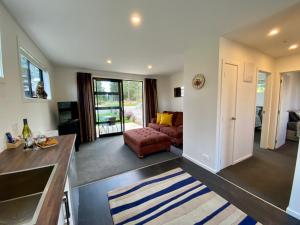 a large living room with a couch and a table at Alpine Views and River Tracks in Twizel