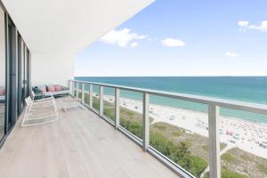 a balcony with a view of the beach at W South Beach in Miami Beach