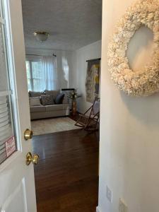 a living room with a large donut hanging on the door at The Mirror Lake Suite in Fayetteville