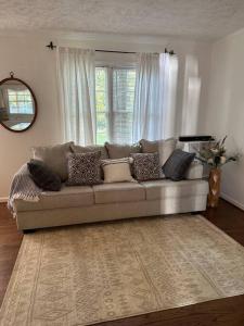 a living room with a couch and a window at The Mirror Lake Suite in Fayetteville
