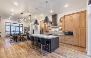 a kitchen with wooden cabinets and a table with chairs at Paradise Retreat at Copper Rock! in Hurricane