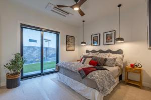 a bedroom with a bed and a large window at Paradise Retreat at Copper Rock! in Hurricane