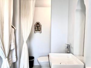 een witte badkamer met een toilet en een wastafel bij No 79 in Tainan in Tainan