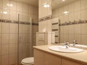 a bathroom with a sink and a toilet and a mirror at Luxueux chalet 5 pièces pour 10 pers. avec sauna, terrasse, proche des pistes et navettes - FR-1-676-22 in Châtel