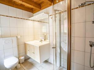 a bathroom with a toilet and a sink and a shower at Chalet 4* pour 15 pers. avec jacuzzi, balcon et poêle à bois, proche du télécabine du Linga et Super-Châtel - FR-1-676-26 in Châtel +17 photos