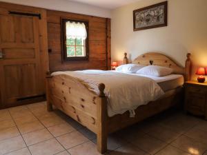 a bedroom with a large wooden bed in a room at Chalet Châtel, 4 pièces, 9 personnes - FR-1-676-44 in Châtel