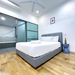 a bedroom with a large bed and glass walls at Iskandar Residences 2BR 5pax 5 mins Legoland Wi-Fi Sky Pool 360 in Nusajaya +24 photos