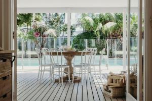 a dining room with a table and chairs at The Beach House, 25 Tomaree Road - fantastic house with pool, linen in Shoal Bay