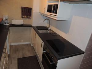 a small kitchen with a sink and a stove at Studio Châtel, 1 pièce, 4 personnes - FR-1-676-98 in Châtel