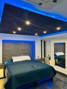a bedroom with a large bed with blue lighting at Ya no tenemos servicio in Mexico City