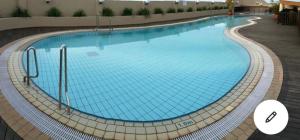 a large swimming pool with blue water at Riverbank suites 405 in Kuching