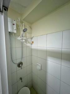 a bathroom with a shower and a toilet at Horizons 101 Condo in Cebu City in Cebu City