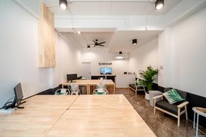 una oficina con mesa, sillas y escritorio en Socialer Coliving & Coworking Space, en Chiang Mai