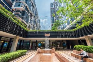a fountain in the middle of a building with buildings at Ooak Residence in Mont Kiara, Kuala Lumpur in Kuala Lumpur
