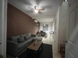 a living room with a couch and a table at ¡Descubre tu oasis en Acapulco! Casa vacacional. in Acapulco
