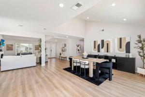 a living room with a table and a couch at Vineyard Chic Oasis: Modern Elegance near Temecula Wineries in Temecula